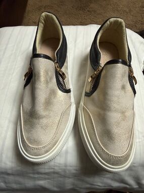 Restricted Metallic Cream Slip-On Loafers with Black Trim and Gold Zippers
